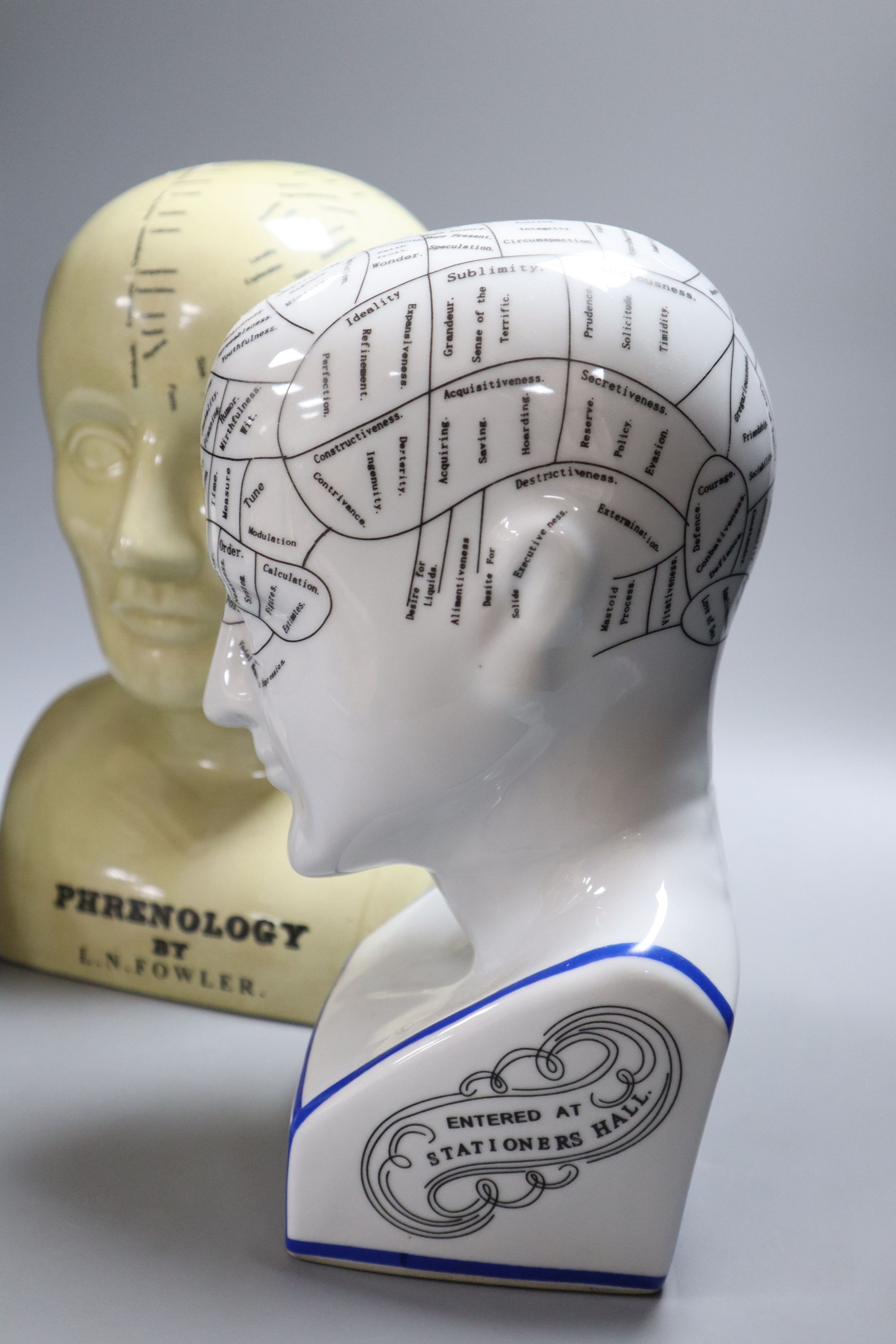 Three reproduction phrenology ceramic heads, by L.M. Fowler, tallest 29cm